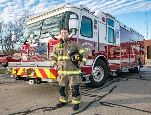 Firefighter technician student by firetruck